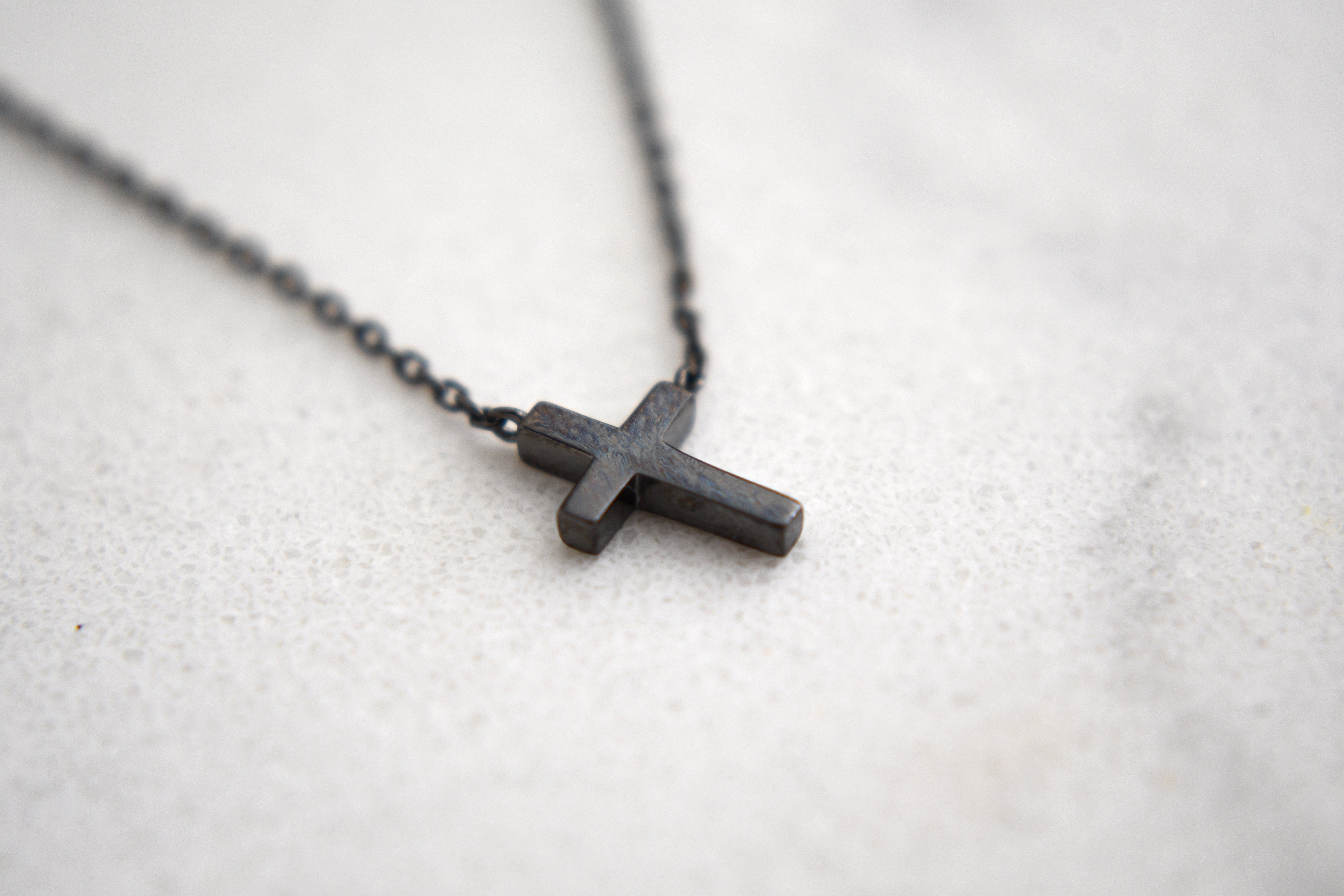 Alexis Leaning Cross Necklace in Black Gold Plating